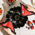 Lodge Cast Iron Fluted Cake Pan with Red Potholders - Cookware Handle Accessory